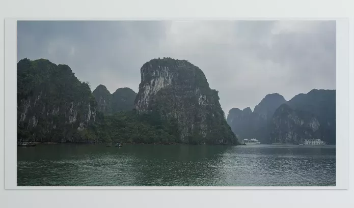 Gumroad - Halong Bay Reference Pack - Towering limestone pillars rise dramatically out of the emerald sea, with their surfaces shrouded in fog.